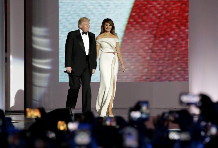 President Donald Trump, left, arrives with first lady Melania Trump at the Liberty Ball, Friday, Jan. 20, 2017, in Washington. (AP Photo/Patrick Semansky)
