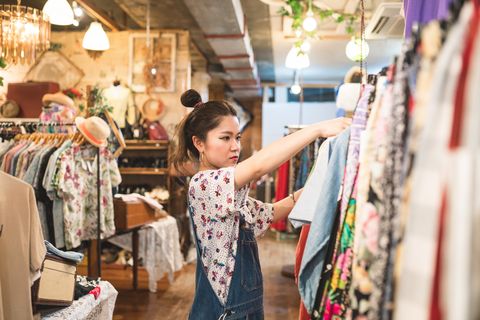 Young woman shopping in a vintage clothing store